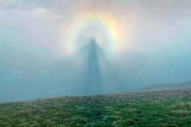 英国男子登山时拍摄到罕见彩虹的照片：彩虹光环的中心有一个天使