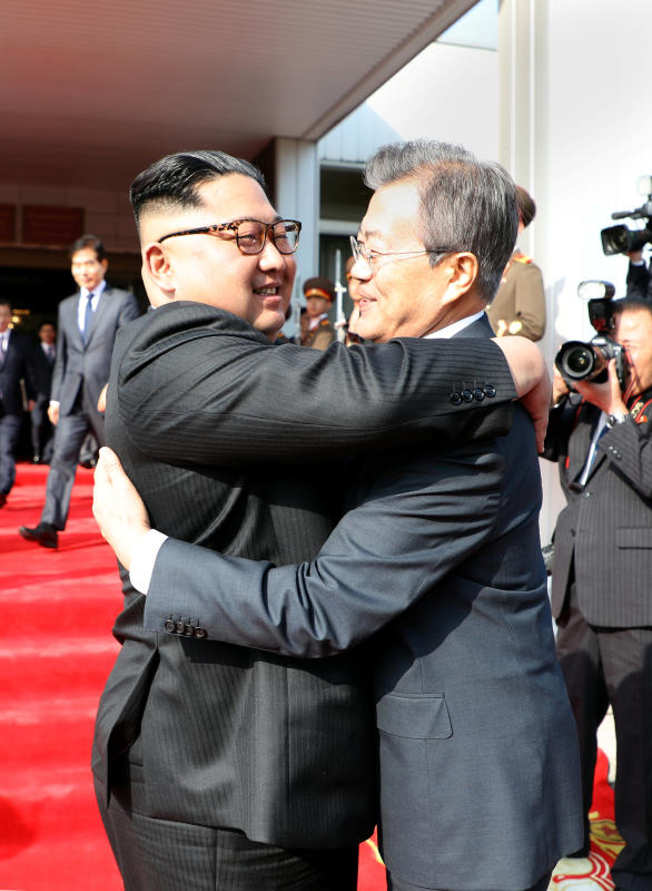 kim and moon hug reuters.jpg