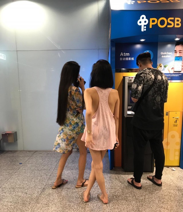 110219 woman at somerset atm.jpg